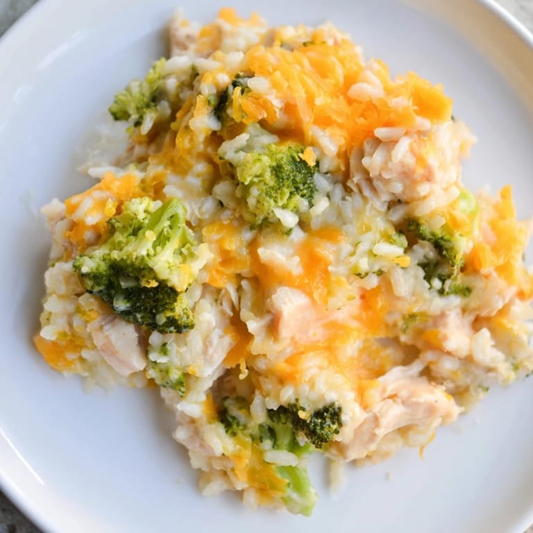 A close-up of a creamy Chicken & Broccoli Rice Casserole, showing tender chicken and fluffy rice.