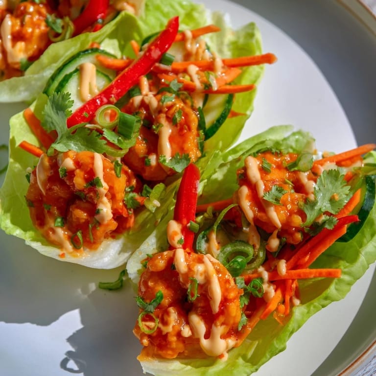 Fresh and flavorful; these shrimp lettuce cups are filled with colorful veggies and creamy sauce.
