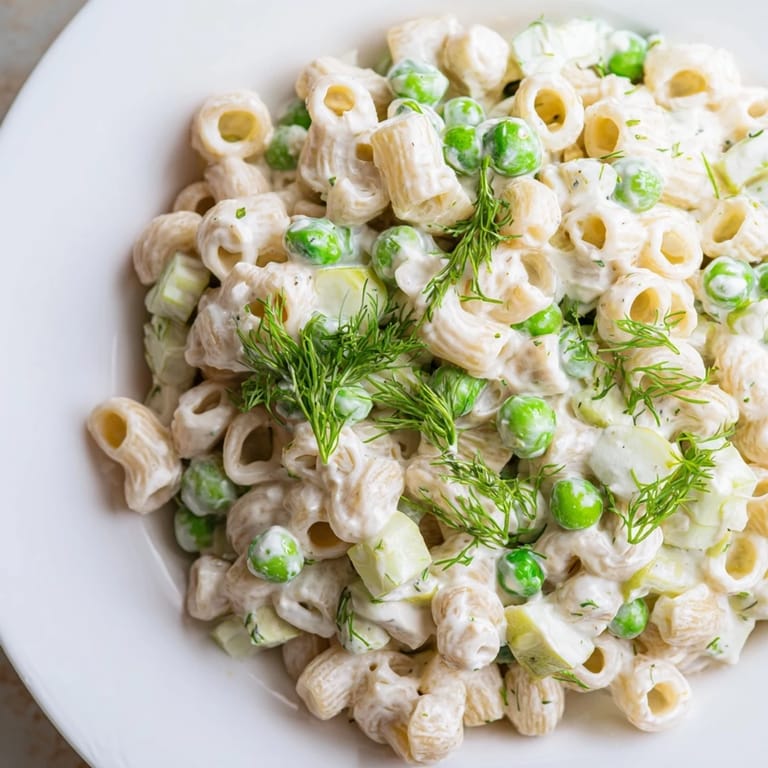 Chilled Creamy Dill Pickle Pasta Salad featuring crunchy celery, red onion, and fresh dill in a tangy, creamy mayonnaise-based dressing.