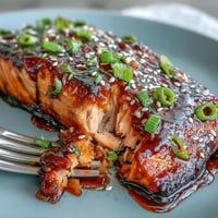 Miso Glazed Salmon with Sesame Bok Choy, a caramelized fillet atop vibrant, tender greens.