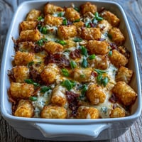 Golden Chicken Bacon Ranch Tater Tot Casserole bubbling with cheese and bacon.